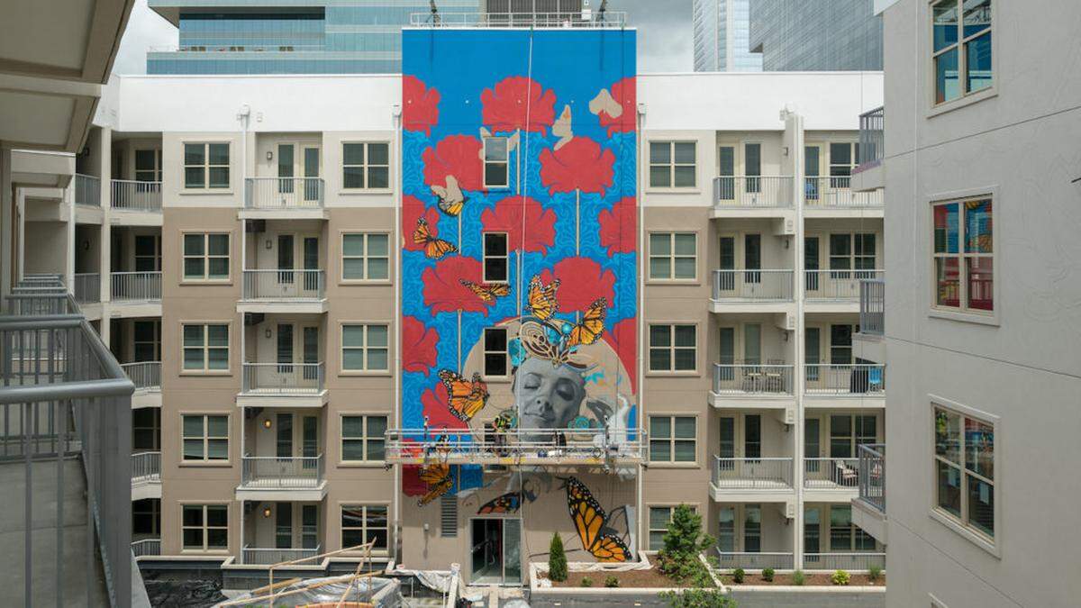 Osiris Rain created the mural at the inner courtyard at NOVEL Stonewall.