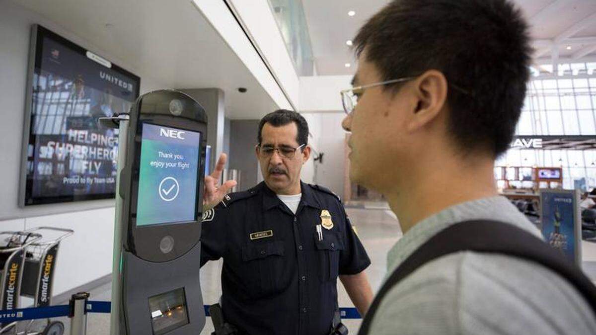 Donna Burton/U.S. Customs and Border Protection<br/>A traveler prepares to get his face scanned before boarding a flight at Houston International Airport in 2018.