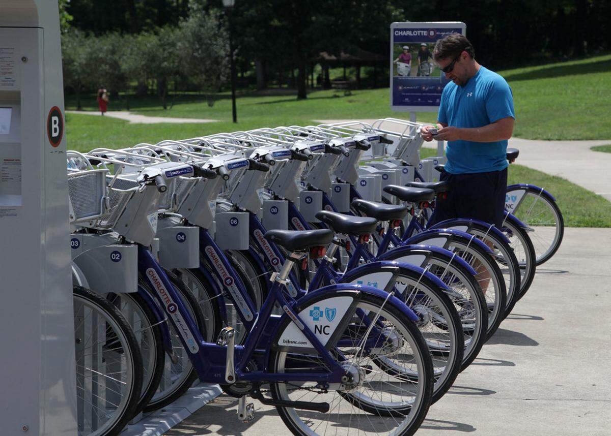 Andy Mock prepares to get a bike from the Charlotte B-cycle station at Freedom Park on Monday, July 29, 2013. "These bikes saved me. I used to have to take my bike to work, which was kind of a hassle," says Mock. He purchased a year-long membership so he can use the bikes whenever he needs them. Charlotte B-cycle is a bike sharing system with 200 bicycles and 20 stations spread out around Charlotte. It is celebrating its one year anniversary this week._MORGAN MCCLOY-mmccloy@charlotteobserver.com