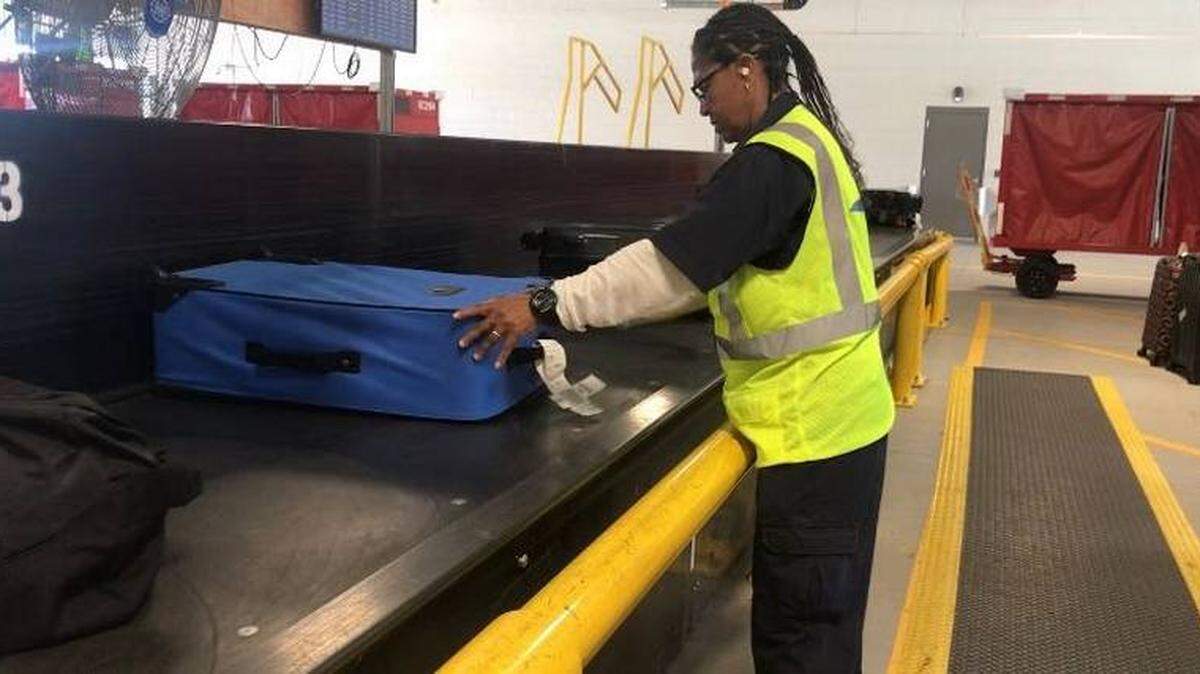 Photo by Maddy Arrowood<br/>An employee checks baggage inside a new facility at Charlotte Douglas International Airport.