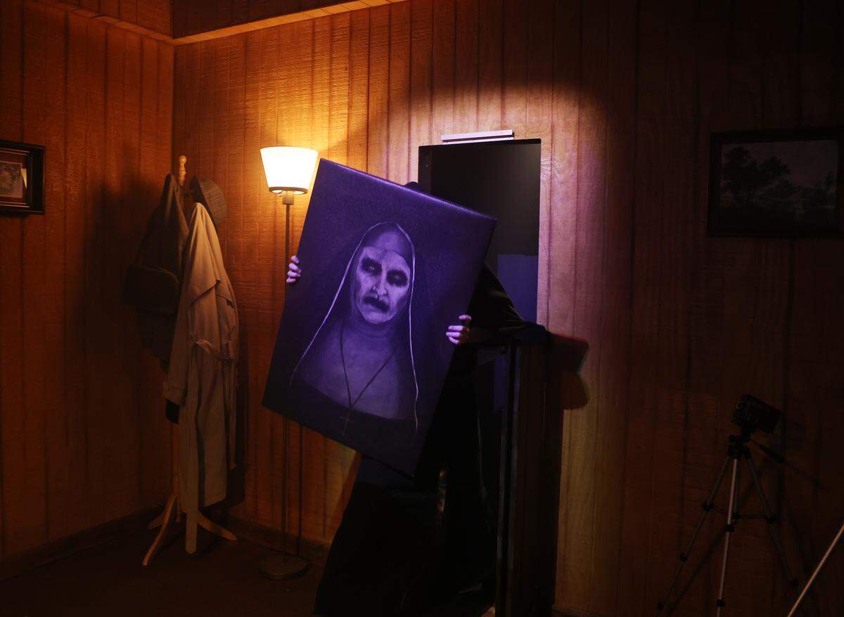 A scary nun emerges from a wall at The Conjuring: Beyond Fear experience at Scarowinds on Tuesday, Sept. 9, 2025.