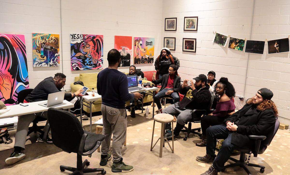 Artists gather to discuss the business of creativity during the first session of “Let’s Talk Dammit” at BlkMrktCLT photography studio at Camp North End.