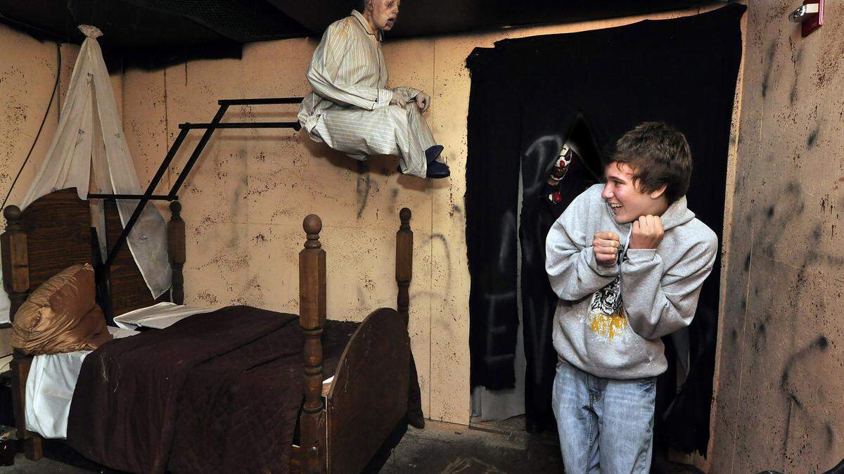 Tyler Lester, 15, of Dallas, N.C. gets a scare as a frightening figure catapults forward from a bed in one of the rooms inside The Haunted Mill in Belmont. For a "where fear meets fun" piece, pegged to big-budget haunted houses in the area (and Halloween), but something that also uses psychologists to get at why we get such a kick out of being scared  DIEDRA LAIRD-dlaird@charlotteobserver.com