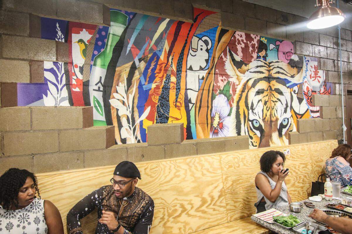 Matt Hooker and Matt Moore, along with Tucker Sward, created the mural at Let’s Meat.