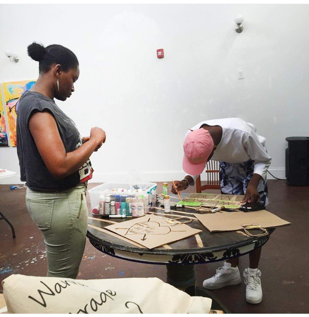 Interns often assist Davita Galloway and Dion Galloway in assembling the bags. Shown here are intern Travis Barnes and CrownKeepers board member, Clarissa Brooks.