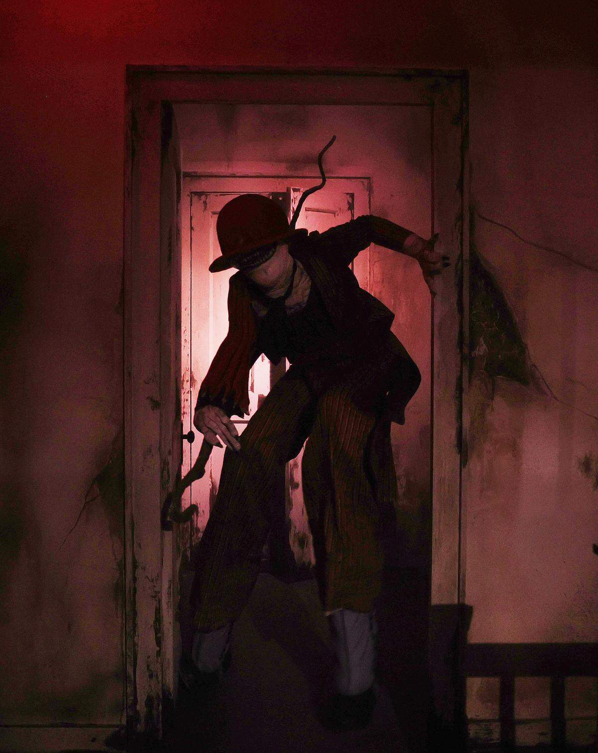 A creature crawls through a doorway at The Conjuring: Beyond Fear experience at Scarowinds on Tuesday, Sept. 9, 2025.