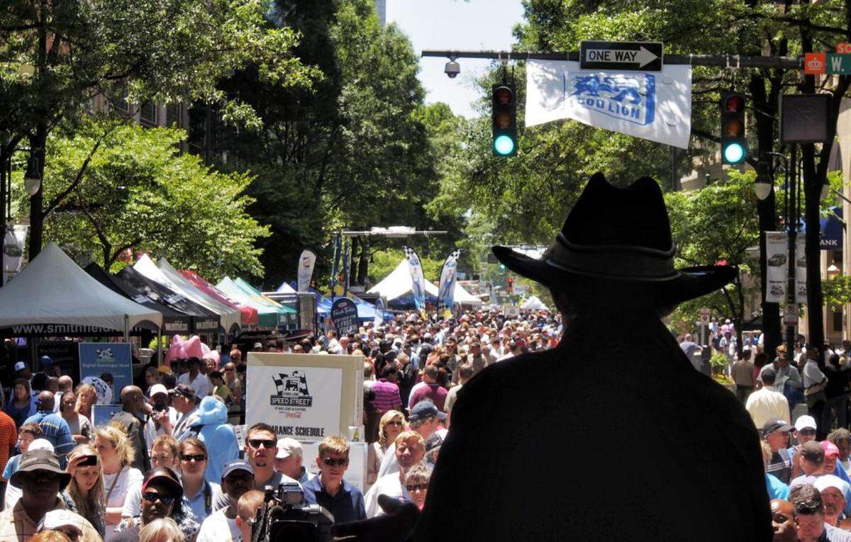 Richard Petty regales fans with stories from his racing career on the Food Lion  stage on 05.24.13. Race fans enjoyed sunny but very windy weather Friday in downtown Charlotte during the Speed Street Festival. The festival is free and runs from noon to 11 p.m. through Saturday.