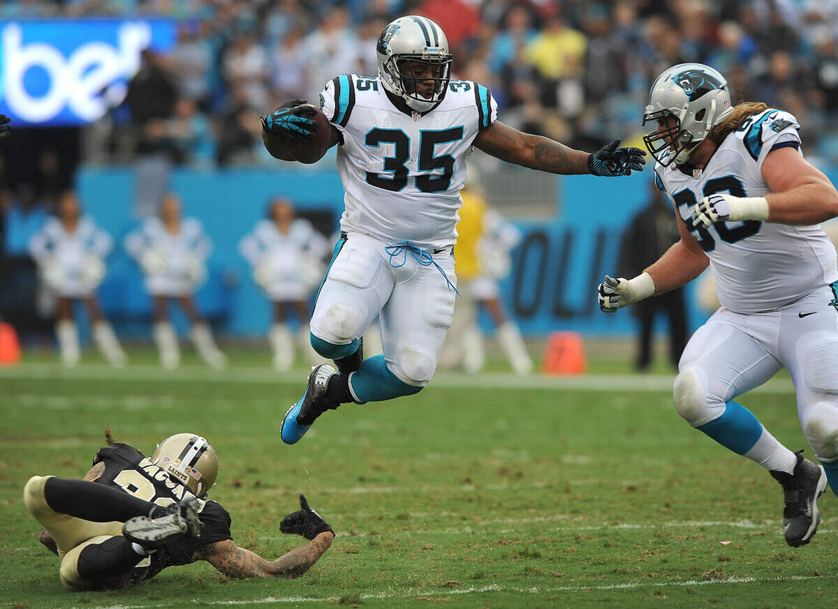 Carolina Panthers full back Mike Tolbert leaps over New Orleans Saints safety Kenny Vaccaro during second quarter action as Panthers guard Andrew Norwell looks on on Sunday, September 27, 2015 at Bank of America Stadium in Charlotte, NC. The Panthers defeated the Saints 27-22.