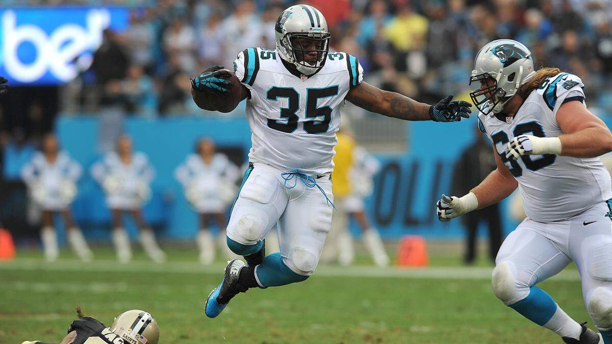 Carolina Panthers full back Mike Tolbert leaps over New Orleans Saints safety Kenny Vaccaro during second quarter action as Panthers guard Andrew Norwell looks on  on Sunday, September 27, 2015 at Bank of America Stadium in Charlotte, NC. The Panthers defeated the Saints 27-22.