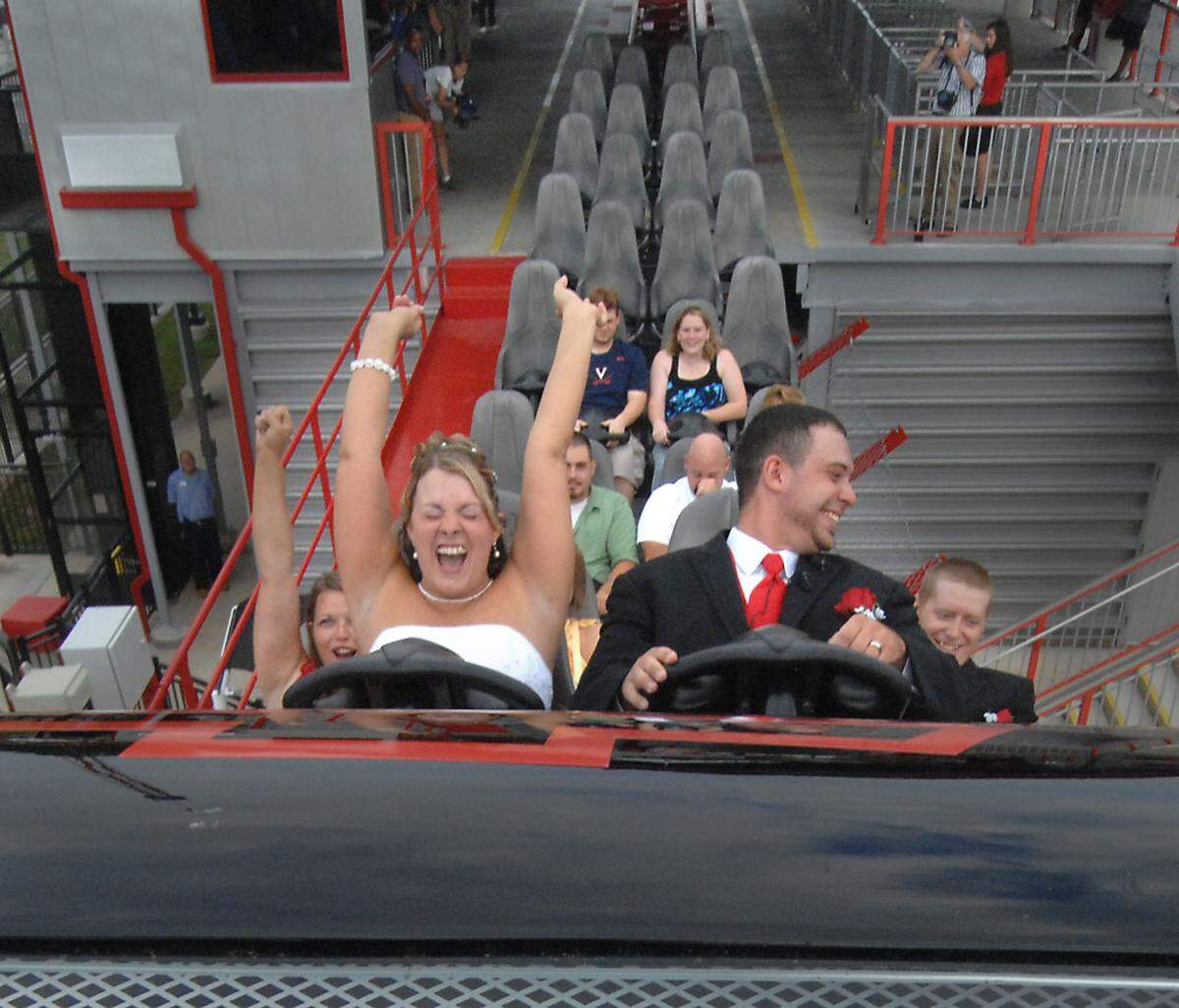 8/20/2011 Wendy and Glen Swearengin take the plunge on the Intimidator at Carowinds Saturday morning. Glen proposed to Wendy on the coaster last year and the couple decided to tie the knot on the ride's platform. Todd Sumlin - tsumlin@charlotteobserver.com