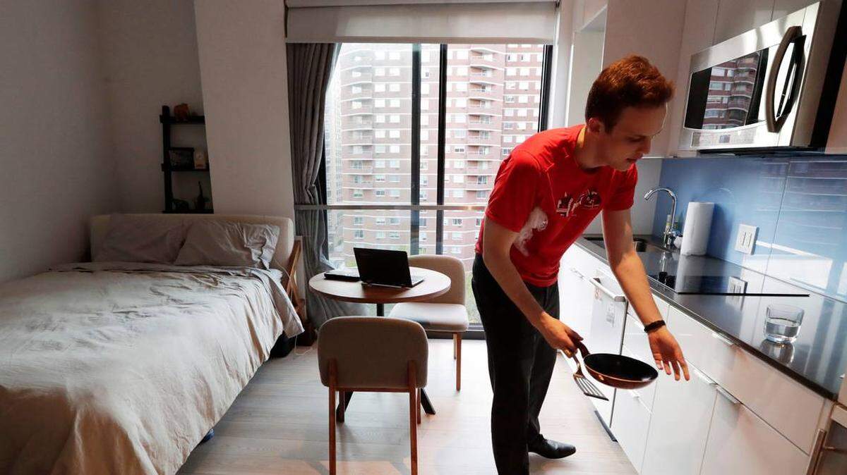 Carmel Place resident Matthew Alexander puts away dishes in his studio apartment in the Kips Bay neighborhood of Manhattan borough in New York. While micro-apartments and tiny living are common in places like New York City and San Francisco, they’re new concepts in Charlotte, where developers are betting there’s a market for people who want to live small. Photo by Kathy Willens AP