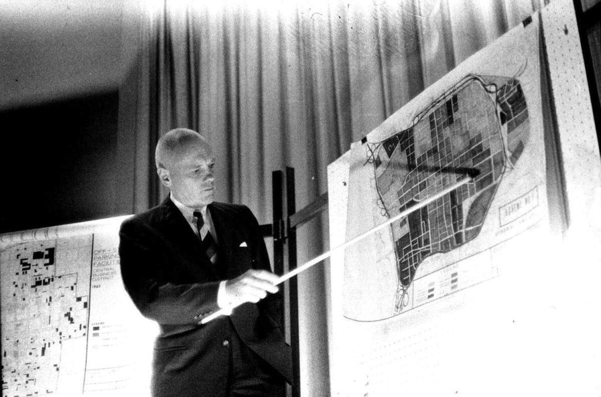 MAKING A POINT -- Architect  A.G. Odell Jr. points to the map showing Charlotte's core area during the presentation of the Charlotte Downtown plan to local business leaders.