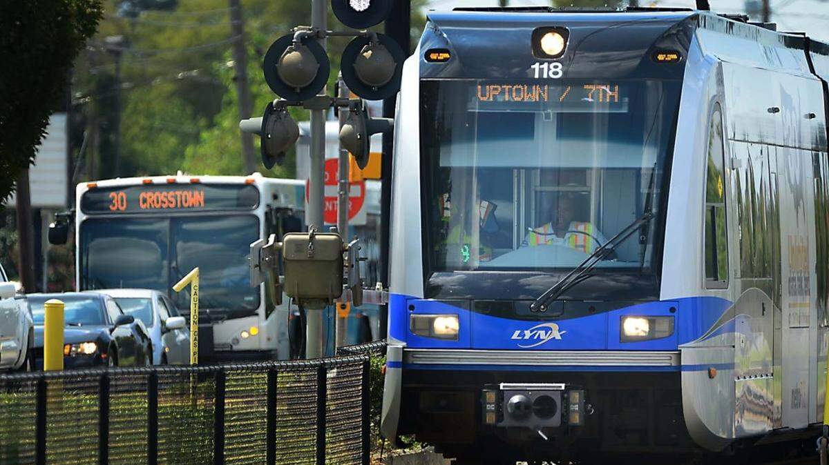 FILE - Photo of a Blue Line light rail car and Charlotte Area Transit System bus in Charlotte.