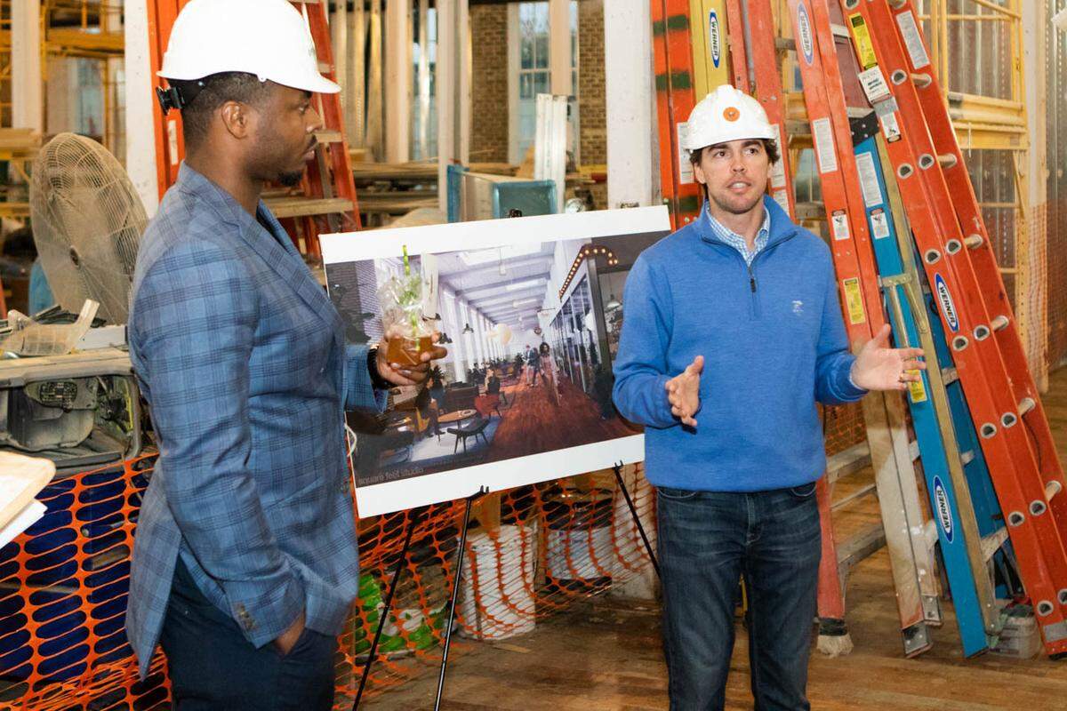 Photo by Alex Cason Photography<br />Jay Levell, right, co-founder with White Point partners, gives a tour during a Hard Hat Happy Hour on Monday evening.