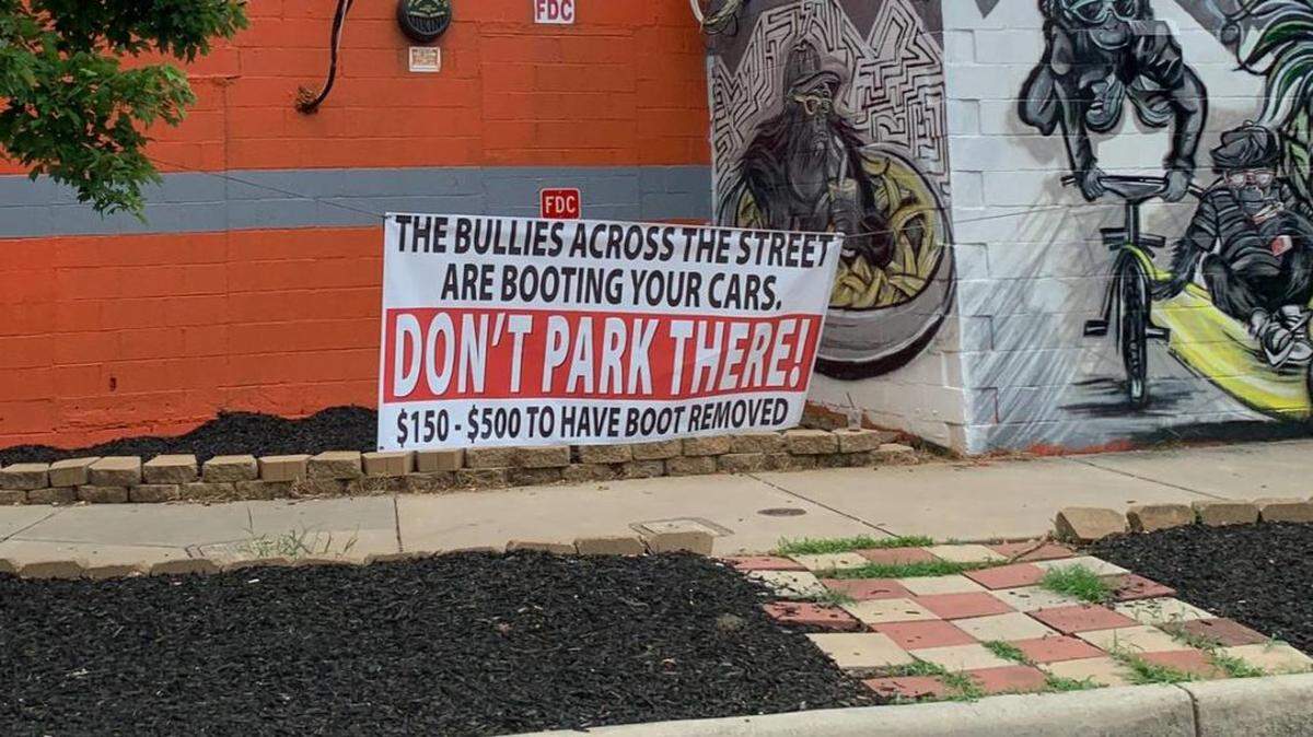 Photo by Melissa Oyler <br/>The sign in front of The Peculiar Rabbit, warning customers about the lot across the street.