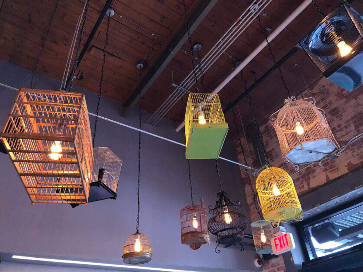 Photo by Jessica Swannie<br/>Birdcage lights recreate the Asian street feel.