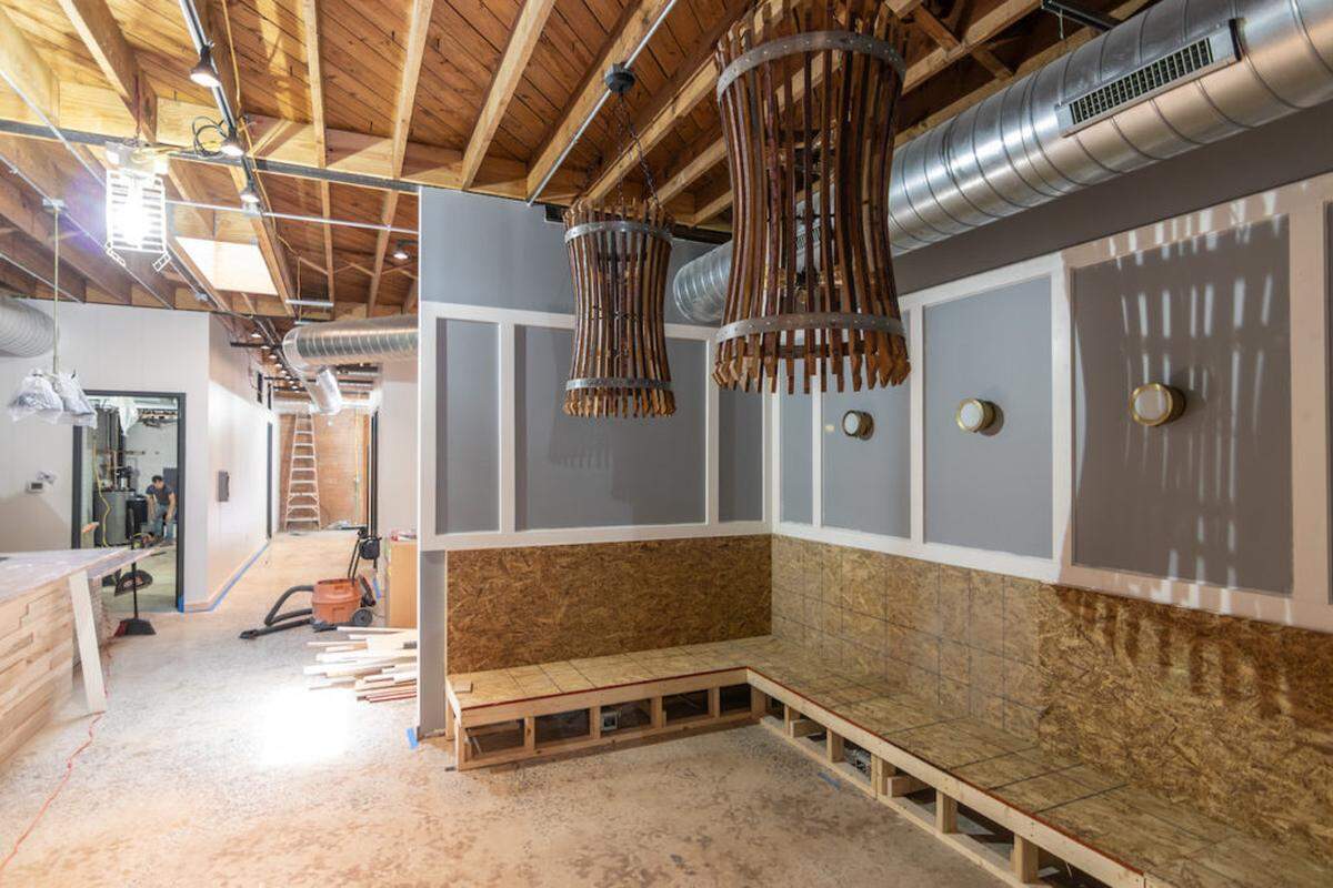 Alex Cason Photography<br/>The Hobbyist will open in Villa Heights in June, and this space, shown under construction in May, has become a blue leather booth with handmade wood tables.