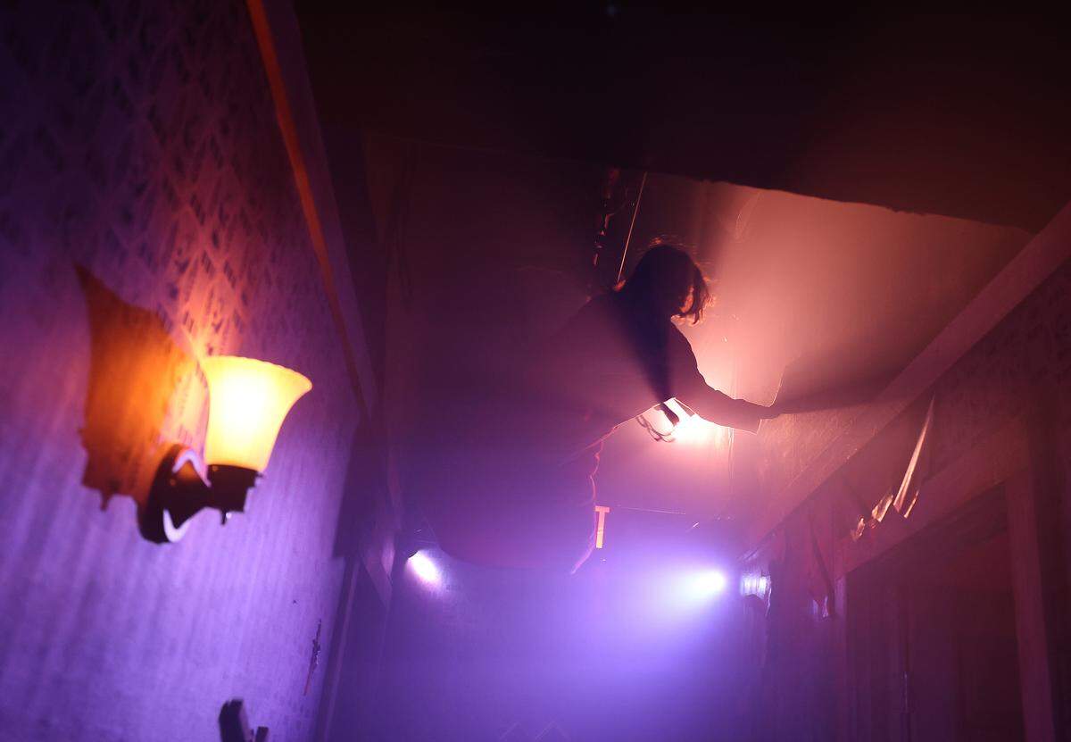 A scary creature crawls around the ceiling of a room at The Conjuring: Beyond Fear experience at Scarowinds on Tuesday, Sept. 9, 2025.