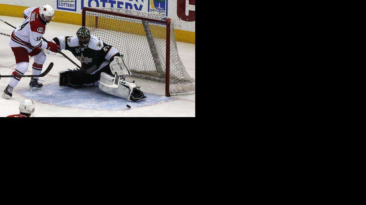
Texas Stars goalie Cristopher Nilstorp, right, blocks a shot by Charlotte Checkers forward Justin Shugg in the first period of an American Hockey League match at Time Warner Cable Arena Friday, Jan. 17, 2014. 
