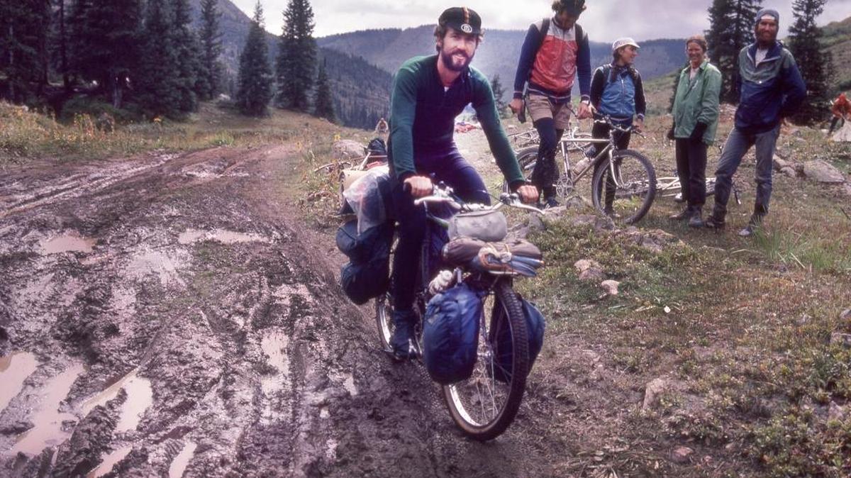 Mike Rust pedaling one of his early handmade mountain bikes over Pearl Pass, Crested Butte Colorado. Circa 1981.