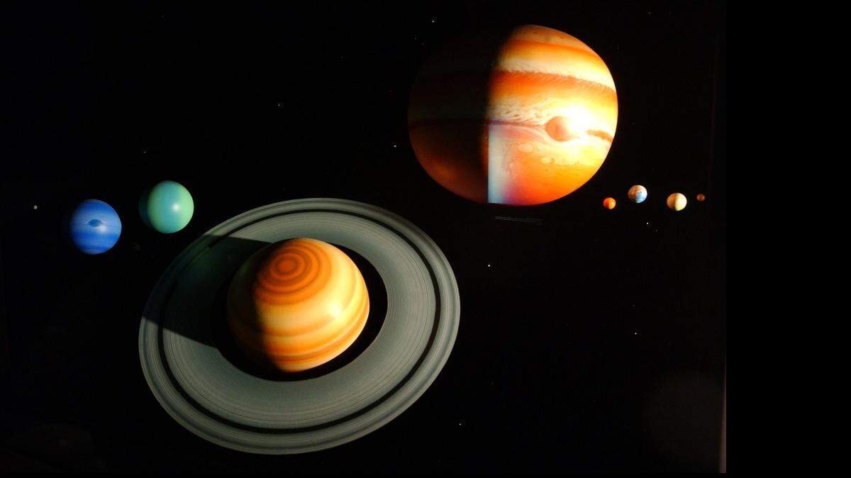 
PLANETARIUM4.CHN.081806.HLL -- CHAPEL HILL,NC -- Detail photo of one of the Morehead Planetarium exhibit hall displays of the current nine planets in our solar system, from left to right: Pluto (very small speck at far left),Neptune, Uranus, Saturn, Jupiter, Mars, Earth, Venus and Mercury.The possible addition of three new planets to our nine planet solar system may change the live vocal presenation some at the planetarium programs, but not the programmed Planetarium shows for now.STAFF/HARRY LYNCH
