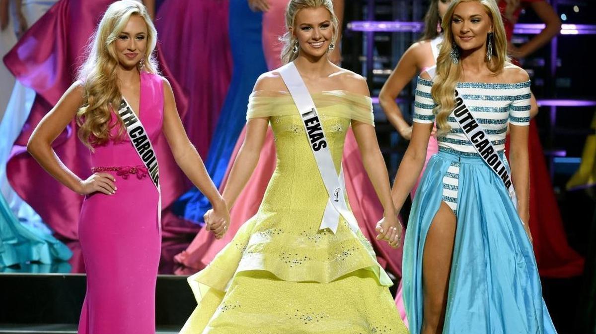 LAS VEGAS, NV - JULY 30: The top three finalists (L-R) Miss North Carolina Teen USA 2016 Emily Wakeman, Miss Texas Teen USA 2016 Karlie Hay and Miss South Carolina Teen USA 2016 Marley Stokes hold hands during the 2016 Miss Teen USA Competition at The Venetian Las Vegas on July 30, 2016 in Las Vegas, Nevada. Hay went on to be named Miss Teen USA 2016 and Wakeman was named the first runner-up.