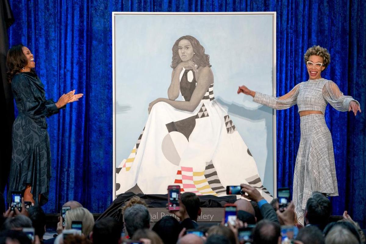 Amy Sherald, right, at the 2018 unveiling of her portrait of former first lady Michelle Obama. She will go on tour in 2021 to talk about the portrait.