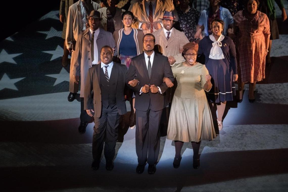 Ralph (Overton), Martin (Davis) and Rosa Parks (Avalon Cutts-Jones) march in protest of busing laws in Montgomery.