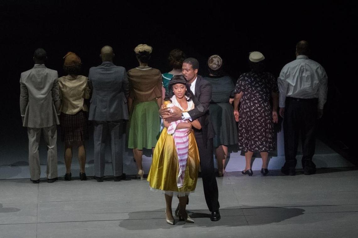 Martin (Davis) consoles Coretta (Mitchell) after their home is bombed.