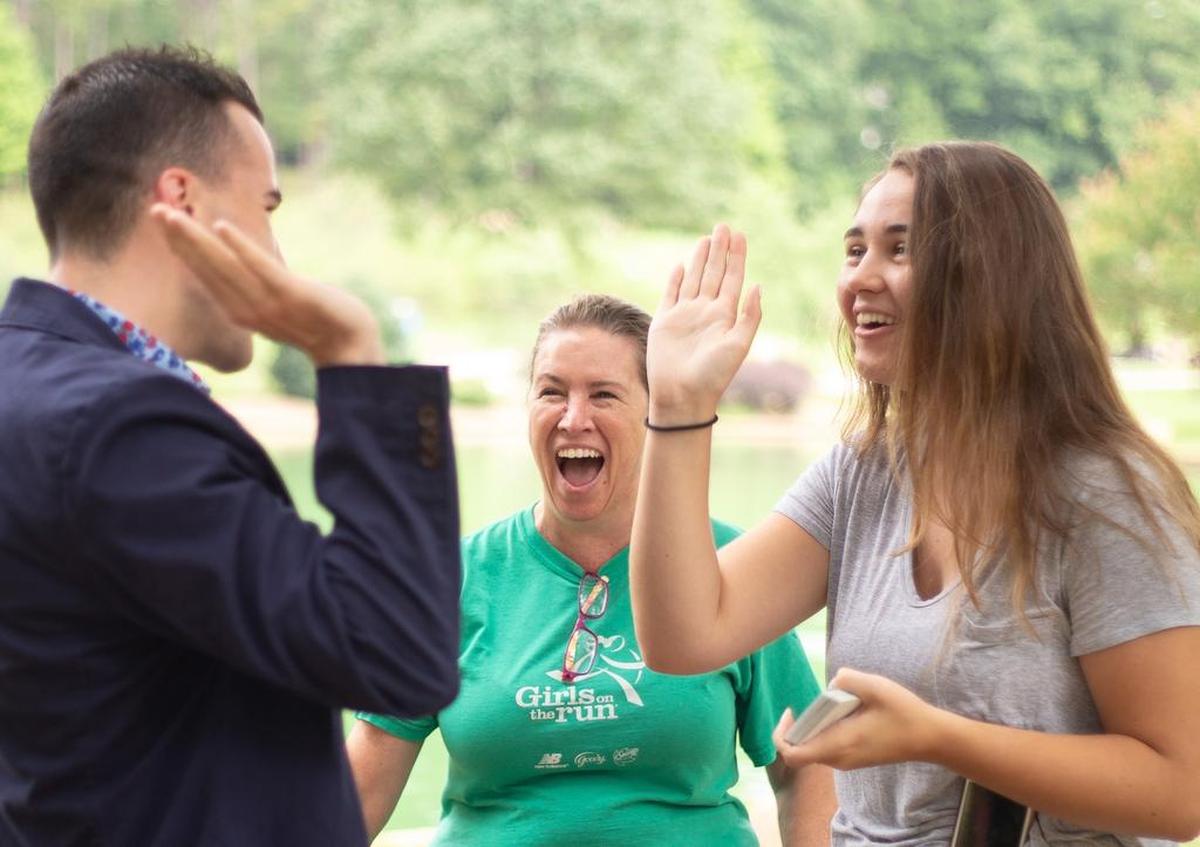 Sigmon gives a high five to Emma McDermott after guessing the card she picked; Christy McDermott is suitably amazed.