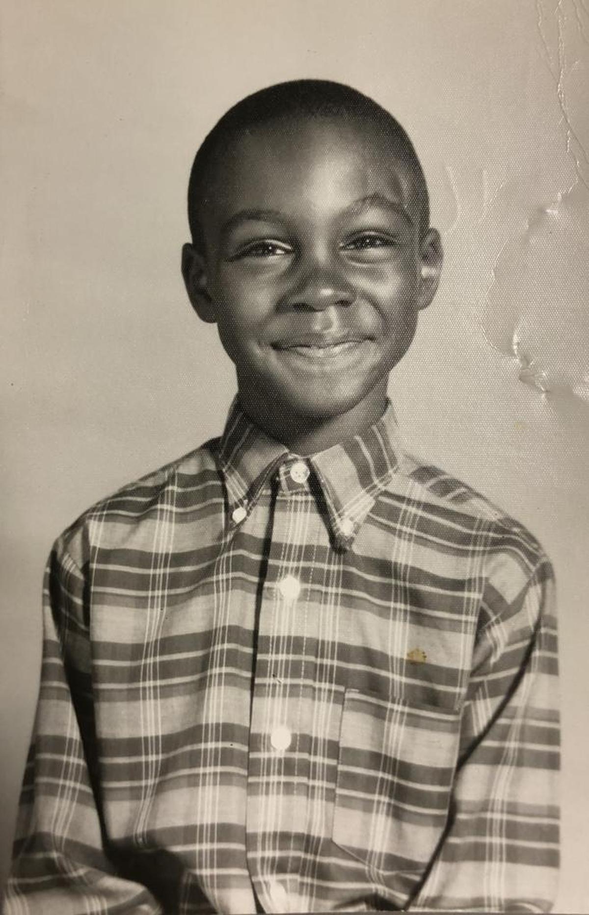 Love – captioned “Buddy” on the photo’s back – at 7 years old. Of this photo, Love says: “I literally weep from overwhelm if I look at the 7-year-old for long. He is so sweet, vibrant, beautiful, and bubbling over with joy.”