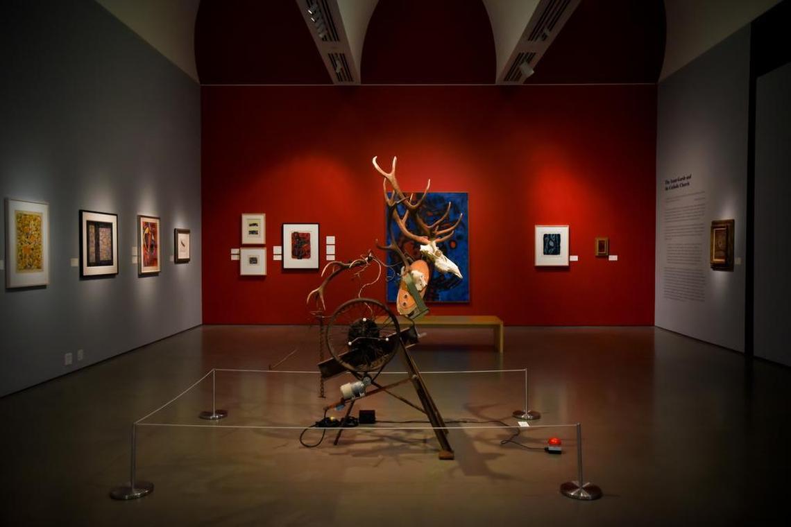 An installation view of “Wrestling the Angel,” with a Tinguely sculpture at center.