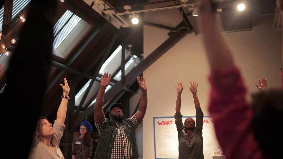 Urban Ministry Center and Men’s Shelter of Charlotte caregivers take part in Jody Wood’s “Choreographing Care” workshop at the McColl Center.