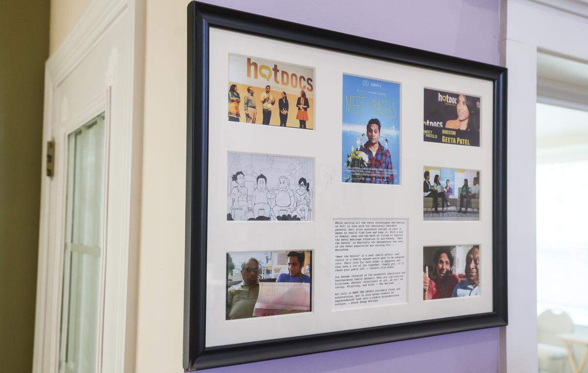 A collage with stills from the movie “Meet the Patels”, as well as candid photos from film festivals where the movie was shown, hangs inside the house of Vasant and Champa Patel in Charlotte on Monday, November 24, 2025. 