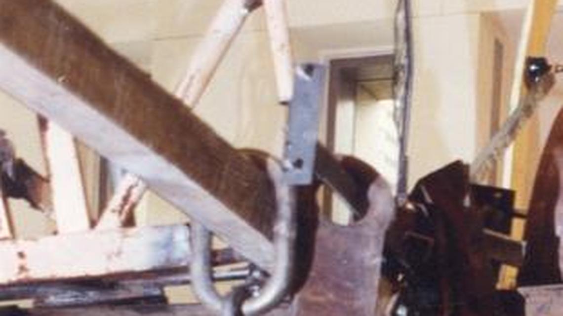 A June 26, 1991, Observer file photo of Tinguely, looking up at “Cascade” in the Carillon building on West Trade Street.