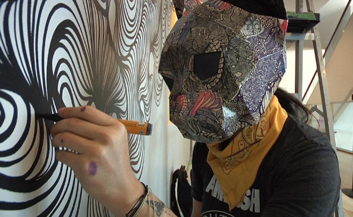 Charlotte mural artist Owl at work on a piece at the Mint Museum for the upcoming Talking Walls festival.
