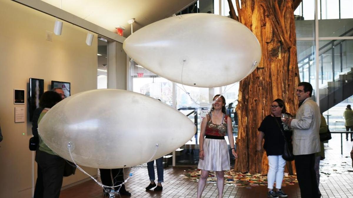 Gallery visitors interact with Jed Berk’s Blubber Bots at the opening of “Keeping Watch on Air.”