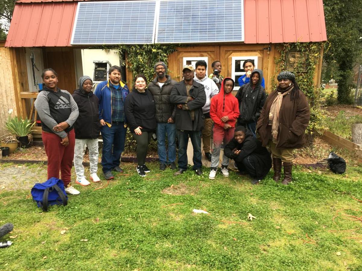 Behailu students and volunteers flank (beginning third from left) Juan William Chavez, Bree Stallings (Behailu’s lead teaching artist), Trevor Hoskins (culinary arts instructor) and master gardener Bernard Singleton.