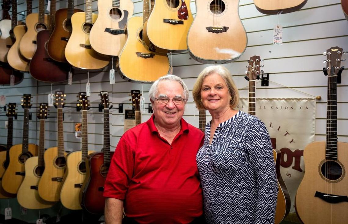 Marion and Mary Helen Holloway pose for a portrait in their Monroe store, Holloway's Music Center.