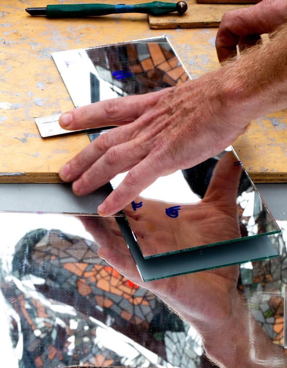 Clayton Venhuizen measures and cuts the new glass to fix the Firebird’s damaged tiles. Each piece is unique and must be cut with precise measurements.