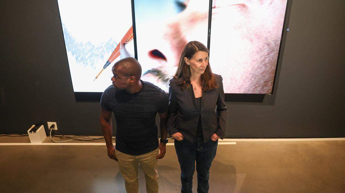 Charlotte dancer and choreographer Davian Robinson, left, and New York-based artist Janet Biggs stand in front of one of the video pieces in the Bechtler Museum of Modern Art’s new exhibit, “Collection, Reframed: We Are Here, Beyond Vision”. Their video and sound installation is an immersive, multi-sensory show.