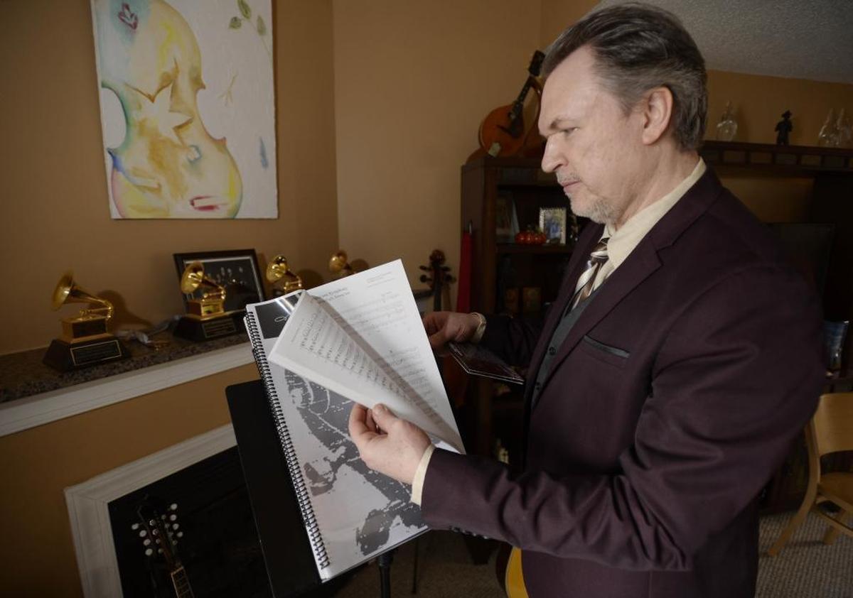 O’Connor flips through the score of his “Americana Symphony,” which the Charlotte Symphony Orchestra will play Feb. 2-3.
