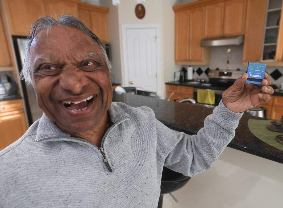 Vasant Patel holds up a promotional matchbook for the 2014 film “Meet the Patels”, which has the phrase “Finding the perfect match isn’t easy” printed on the opposite side, a nod to the plot of the film, in which Patel and his wife, Champa, help their son, Ravi, find a wife of his own.