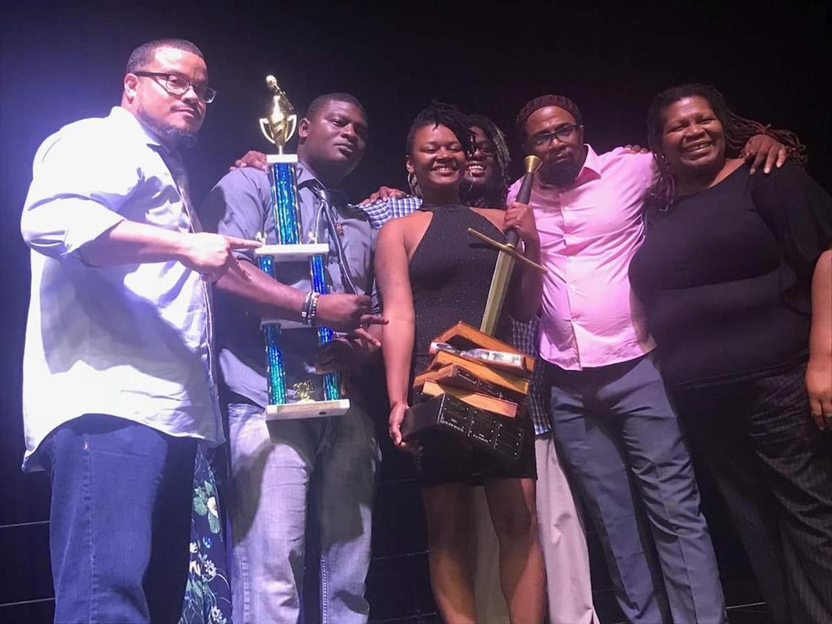 In this 2018 file photo, Jay Ward, far left, celebrates with fellow members of SlamCharlotte, which won the National Poetry Slam Championship in Chicago that year.