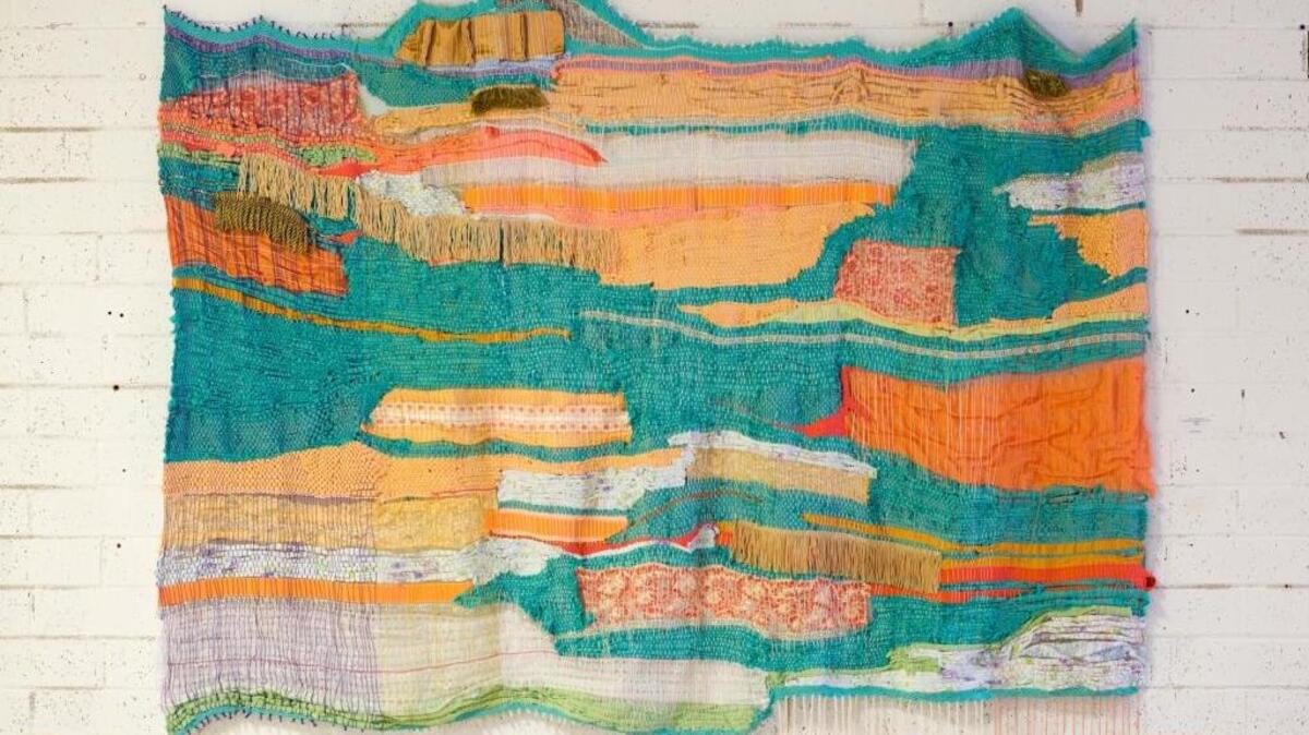 “Stacks (loosely woven),” 2017, by Andrea Vail; woven polyester fabric, decorative trims, varied materials.