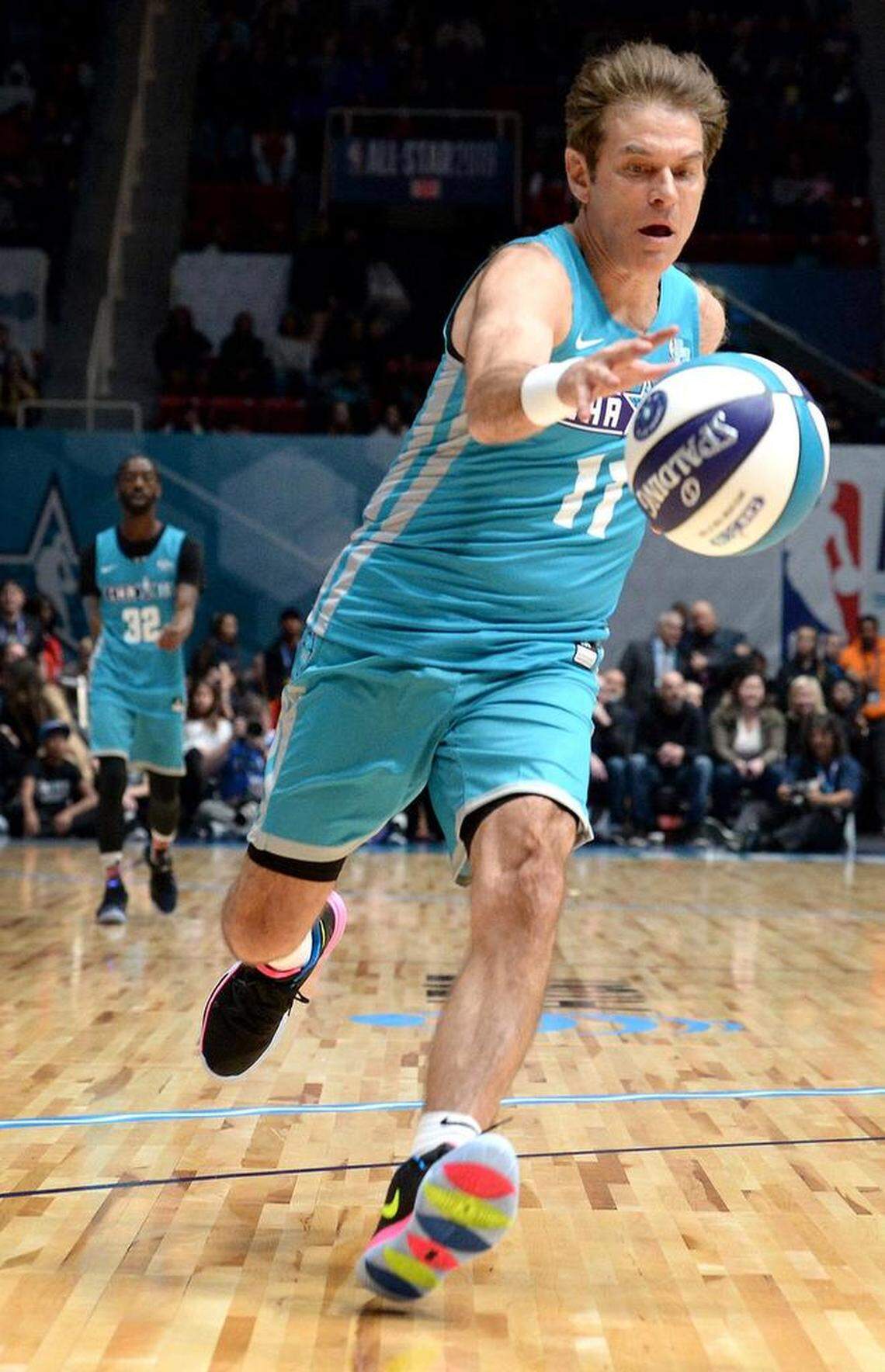 TV personality Dr. Oz chases down a loose ball during the NBA All-Star Celebrity Game.