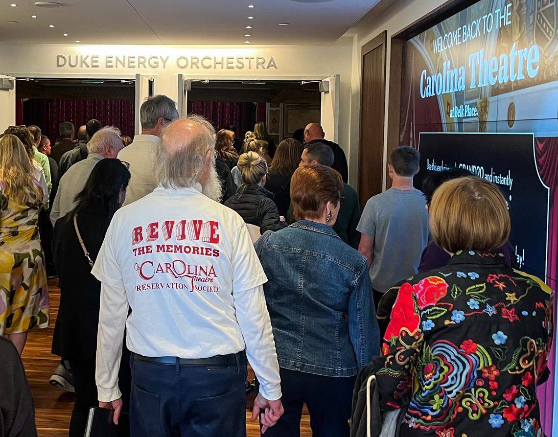 People walk through the lobby of the newly renovated Carolina Theater in uptown during its grand re-opening.