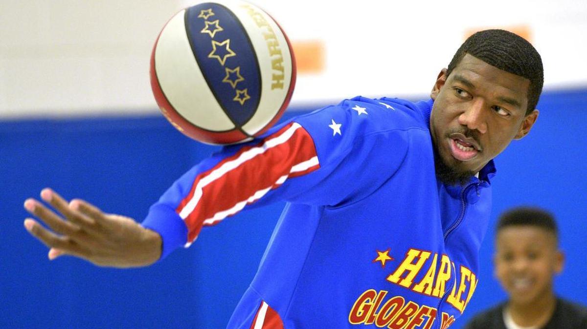 Harlem Globetrotters Anthony Buckets Blakes does tricks for children during a class assembly at Hammond Hill Elementary School in North Augusta, S.C.
