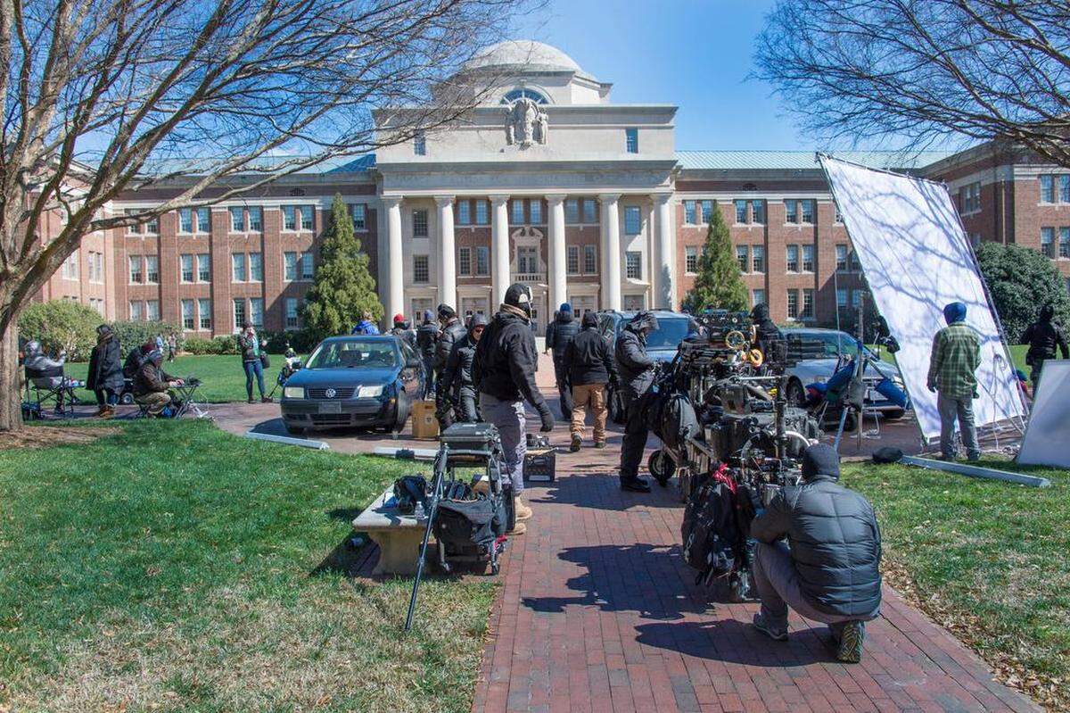 Crews work outside Davidson College's Chambers Building, which stands in for the Transylvania University Library.