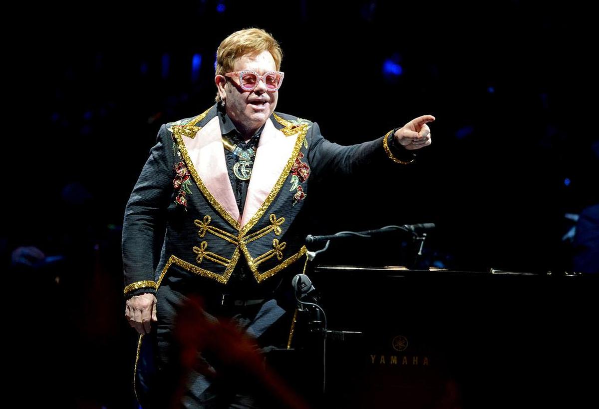 Elton John acknowledges the cheers of fans during Tiny Dancer during his Farewell Yellow Brick Road show at Spectrum Center in Charlotte, NC on Wednesday, November 6, 2019.